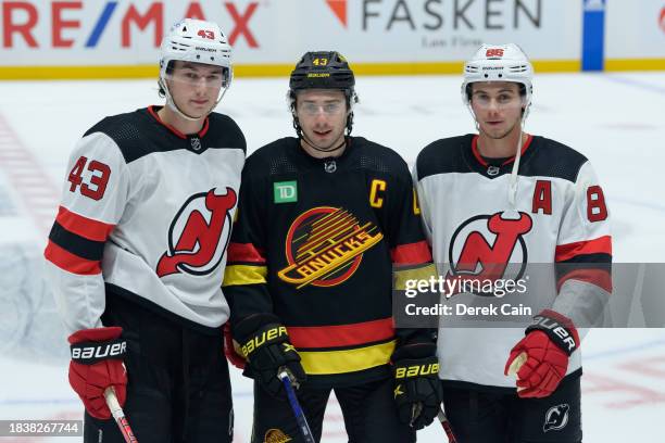 Brothers Luke Hughes of the New Jersey Devils Quinn Hughes of the Vancouver Canucks and Jack Hughes of the New Jersey Devils pose for a photo prior...