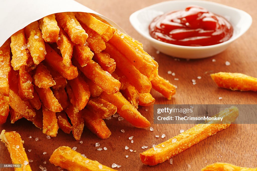 An emptied out cup of sweet potato fries and tomato ketchup