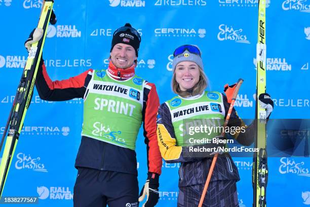 Green bibs for Kasper Stadaas of Norway and Emilie Fleten of Norway during the flower ceremony of the Ski Classics Bad Gastein Criterium on December...