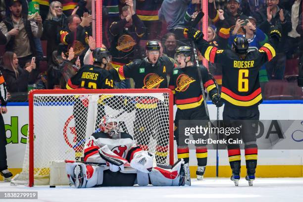 Nils Hoglander is congratulated by J.T. Miller Quinn Hughes and Brock Boeser of the Vancouver Canucks after scoring a goal on Vitek Vanecek of the...