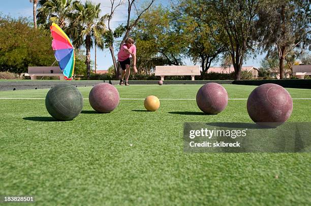 woman playing bocce - bocce ball stock pictures, royalty-free photos & images