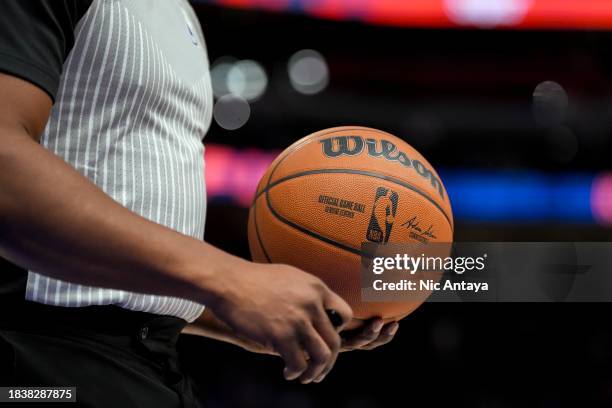 Referee holds a Wilson brand NBA official game ball basketball during the game between the Memphis Grizzlies and the Detroit Pistons at Little...