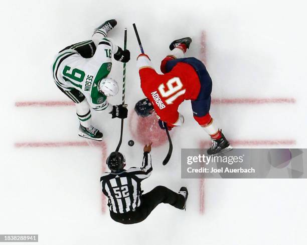 Linesman Shandor Alphonso drops the puck between Tyler Seguin of the Dallas Stars and Aleksander Barkov of the Florida Panthers at the Amerant Bank...