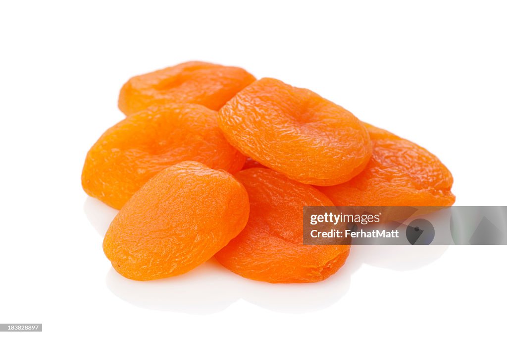 A stack of dried apricots against a white background
