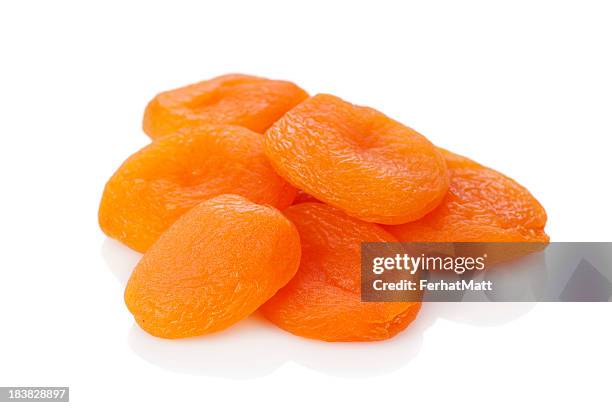 a stack of dried apricots against a white background - droger stockfoto's en -beelden