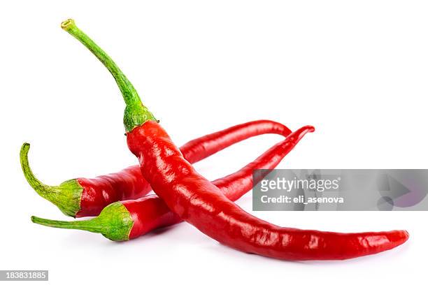 red chilli peppers isolated on white - chilis stockfoto's en -beelden