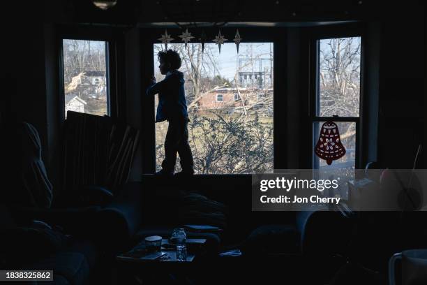 Child stands in the window of the Martin residence in the aftermath of a tornado on December 10, 2023 in Madison, Tennessee. Multiple long-track...