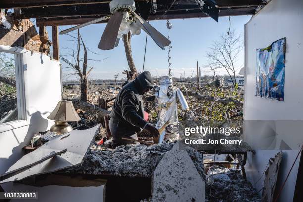 Ronald Harris searches the office of Sabbath Day Church of God in Christ in the aftermath of a tornado on December 10, 2023 in Madison, Tennessee....