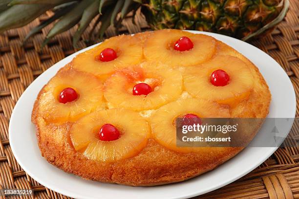 close-up of pineapple upside down cake on white plate - pineapple stock pictures, royalty-free photos & images