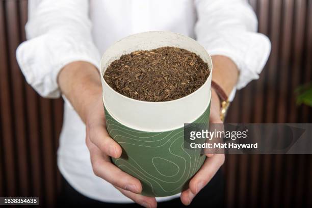 Earth Funeral CEO Tom Harries holds a container of finished human compost at Earth Funeral on December 07, 2023 in Auburn, Washington.