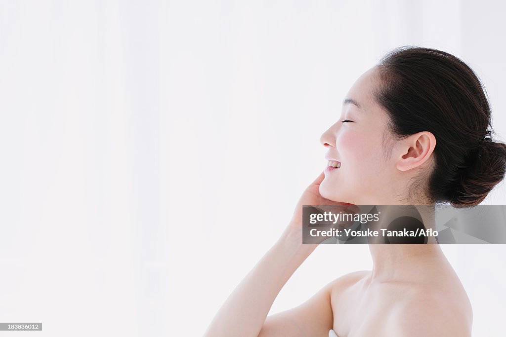 Young woman with no make-up smiling