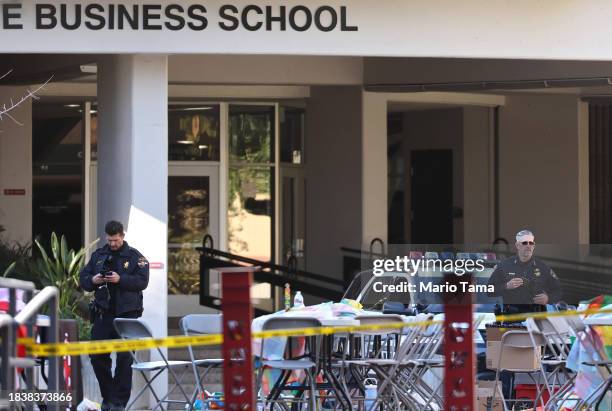 Police officers keep watch near the scene outside Frank and Estella Beam Hall, where the UNLV Lee Business School is located, the morning after a...