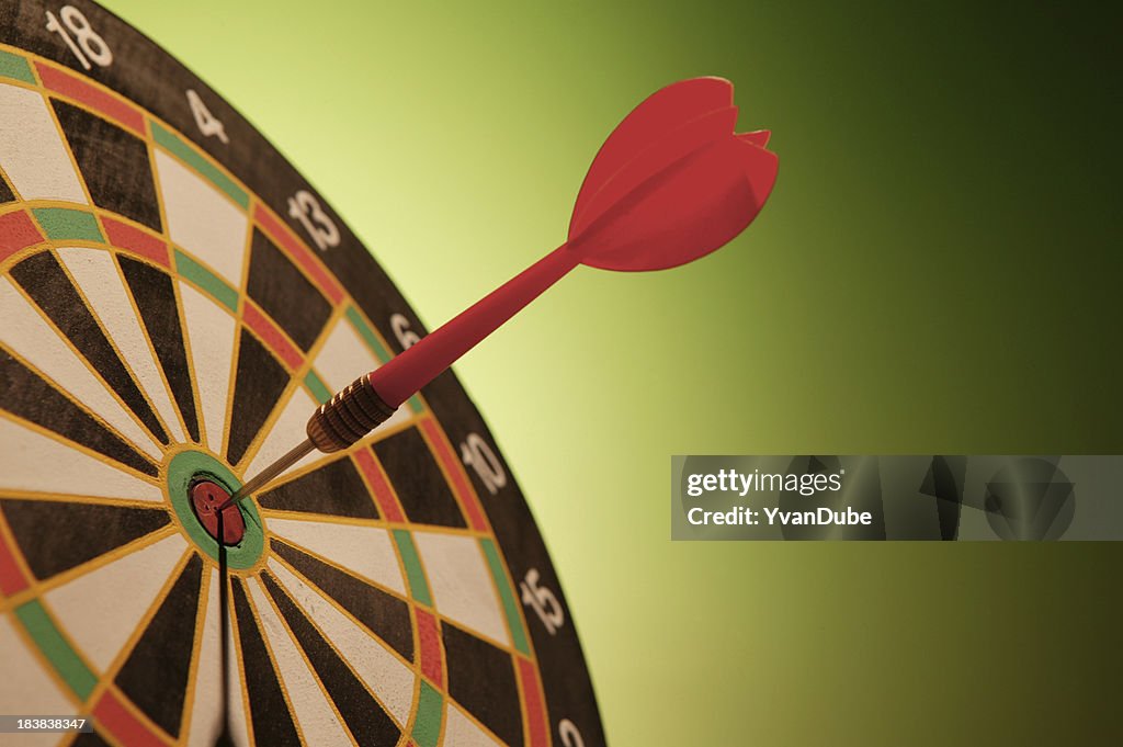Dart in bulls-eye dartboard