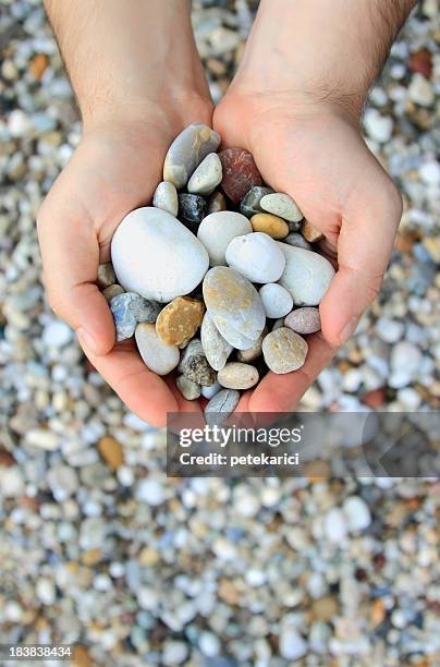 stones in hands - pebble stock pictures, royalty-free photos & images