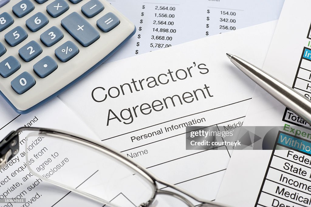 Contractors Agreement Form with pen, calculator
