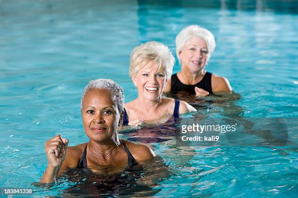 multiracial senior women in water aerobics class - aquagym stock pictures, royalty-free photos & images