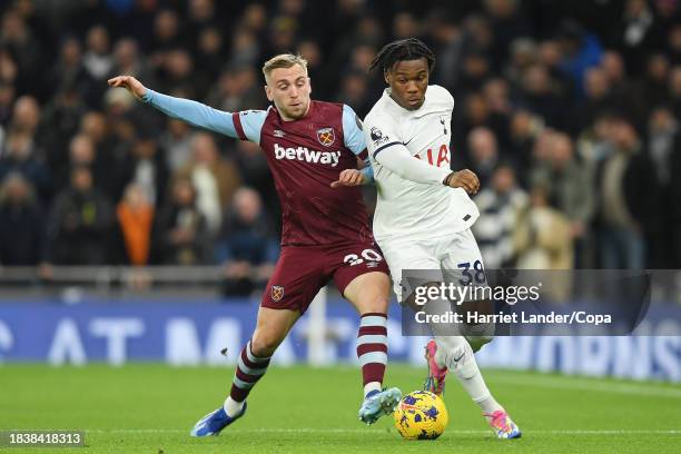 Jarrod Bowen of West Ham United battles for possession with Destiny Udogie of Tottenham Hotspur during the Premier League match between Tottenham...