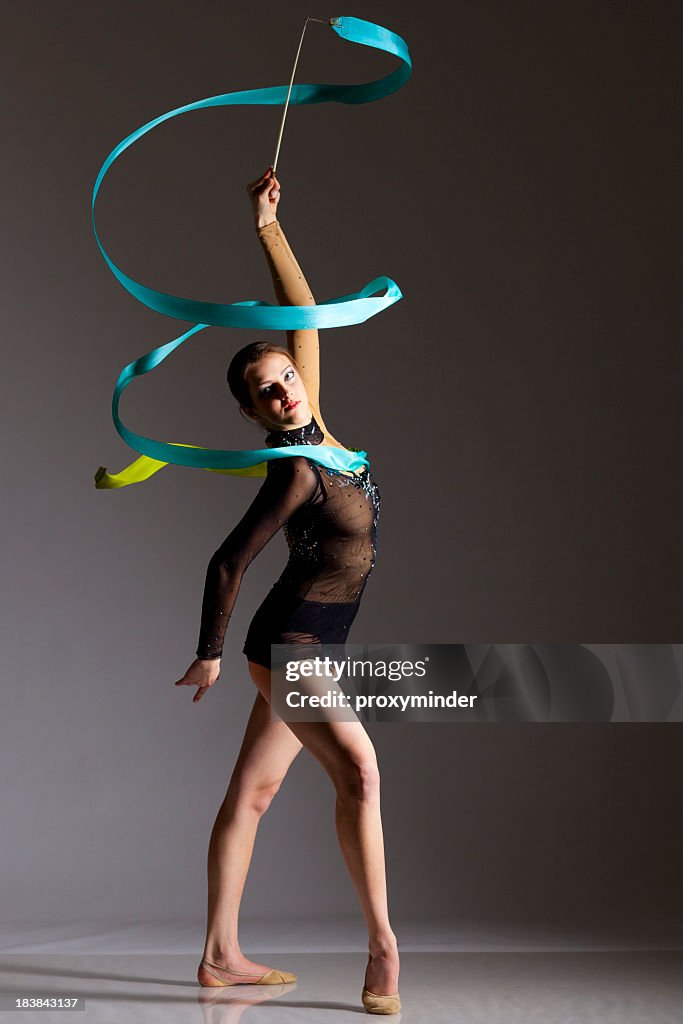 Gymnast girl on grey background