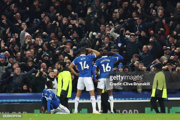 Abdoulaye Doucoure of Everton celebrates with teammates Idrissa Gueye and Beto after scoring his team's second goal during the Premier League match...