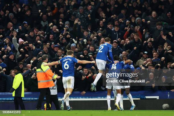 Abdoulaye Doucoure of Everton celebrates with teammates James Tarkowski , Nathan Patterson and Beto scoring his team's second goal during the Premier...