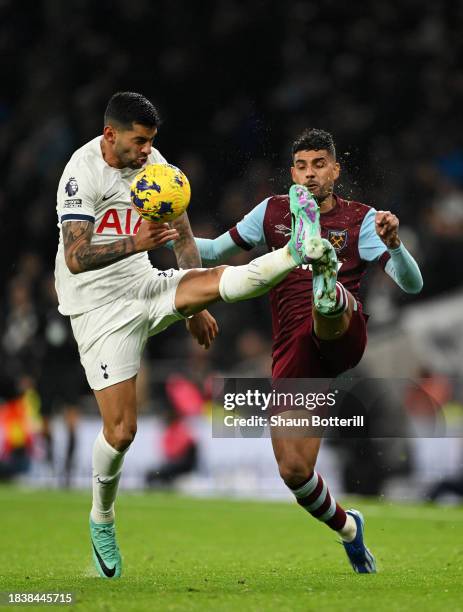 Cristian Romero of Tottenham Hotspur battles for possession with Emerson Palmieri of West Ham United during the Premier League match between...