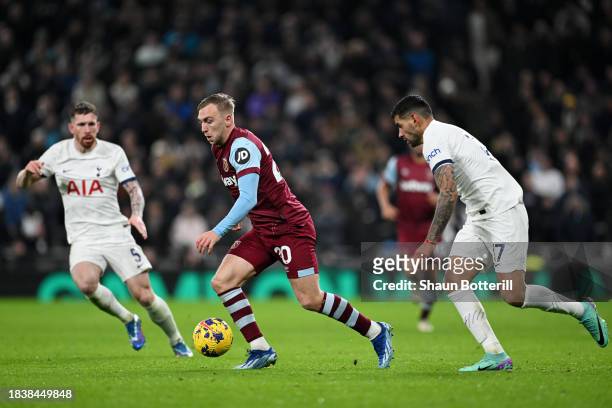 Jarrod Bowen of West Ham United runs with the ball whilst under pressure from Cristian Romero of Tottenham Hotspur during the Premier League match...