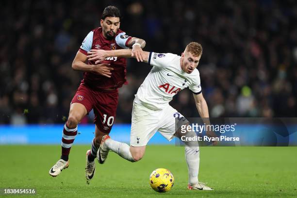 Dejan Kulusevski of Tottenham Hotspur runs with the ball whilst under pressure from Lucas Paqueta of West Ham United during the Premier League match...