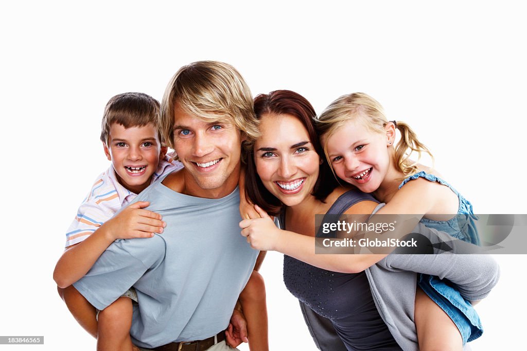 Portrait of happy family of four with kids on parents' backs