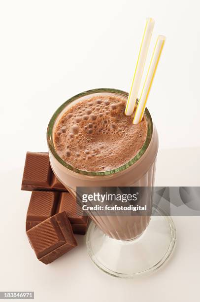 high angle view of chocolate milkshake glass on white backdrop - chocolate milkshake stock pictures, royalty-free photos & images