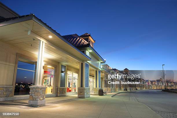 modern store building exteriors at sunset - market retail space stockfoto's en -beelden