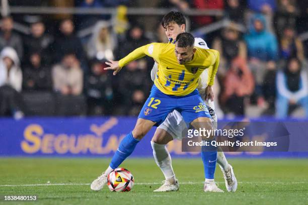 Armando Ortiz of Orihuela CF competes for the ball with g1 during the Copa del Rey second round match between Orihuela CF and Girona FC at Estadio...