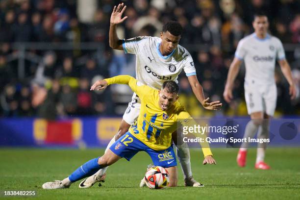 Armando Ortiz of Orihuela CF competes for the ball with Jhon Solis of Girona FC during the Copa del Rey second round match between Orihuela CF and...