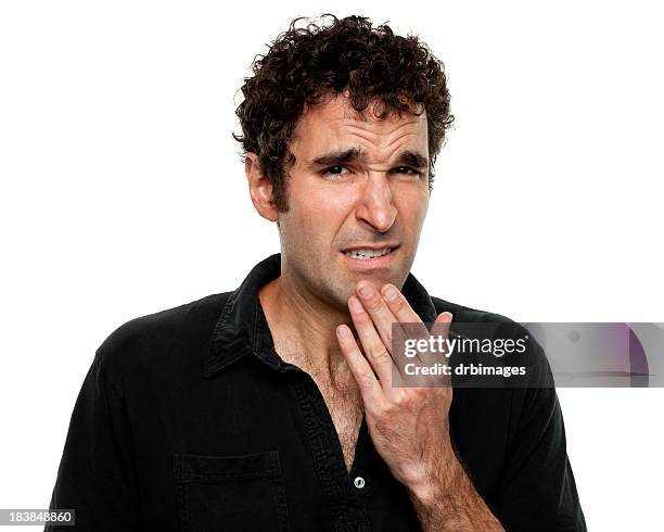 nervous uncertain young man grimacing - awkward stock pictures, royalty-free photos & images