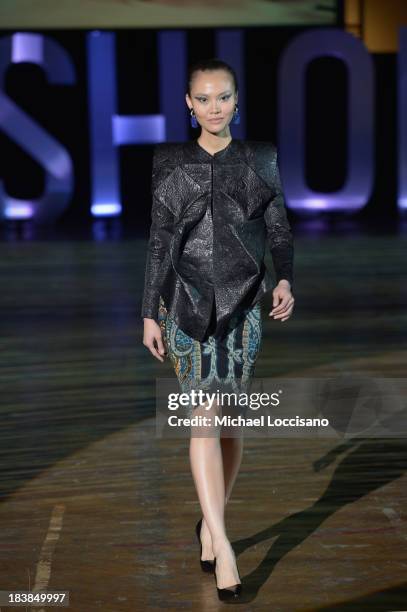 Model wearing Sukeina walks the runway during the 3rd Annual United Colors Of Fashion Gala at Lexington Avenue Armory on October 9, 2013 in New York...