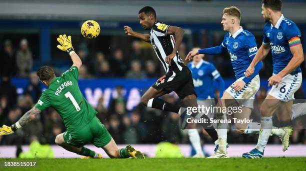 Alexander Isak of Newcastle United chips the ball over Everton FC Goalkeeper Jordan Pickford which goes wide during the Premier League match between...