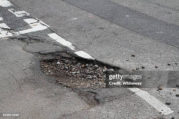 bad repair pothole in road t-junction suffers frost damage - hole stock pictures, royalty-free photos & images