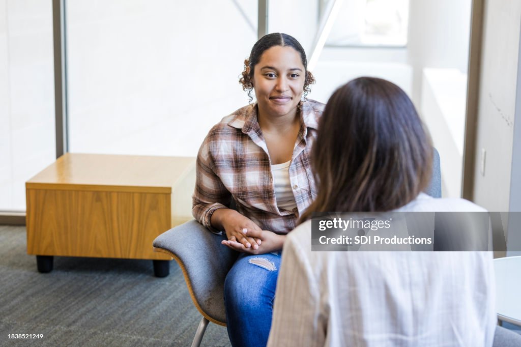 Young adult female student meets with her college counselor