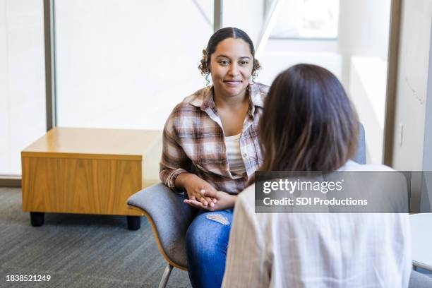 young adult female student meets with her college counselor - university student support stock pictures, royalty-free photos & images