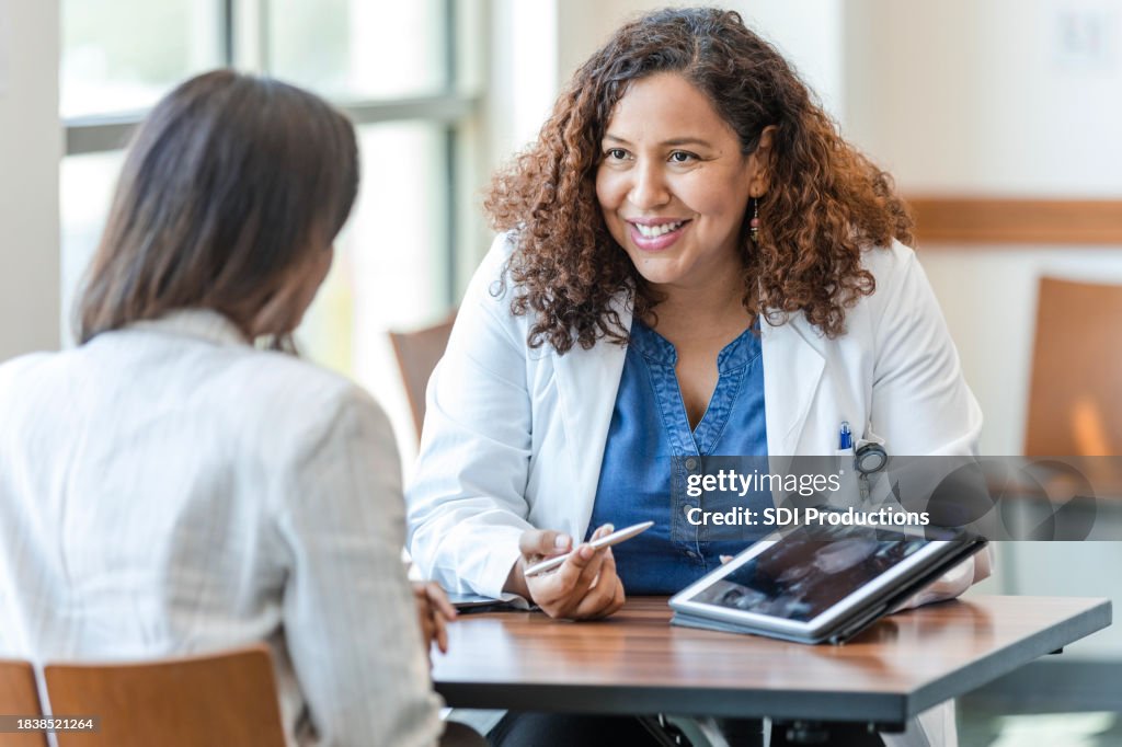 Female gynecologist smiles while explaining test results