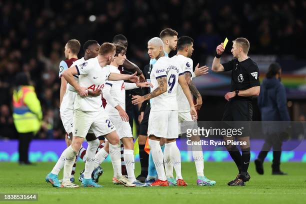 Dejan Kulusevski of Tottenham Hotspur is held back from Match Referee, Michael Salisbury by teammate Pape Matar Sarr during the Premier League match...