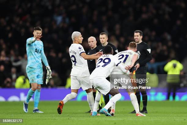 Dejan Kulusevski of Tottenham Hotspur is held back from Match Referee, Michael Salisbury by teammates Pape Matar Sarr and Richarlison during the...