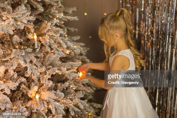 children decorating house for christmas. - christmas candle stock pictures, royalty-free photos & images