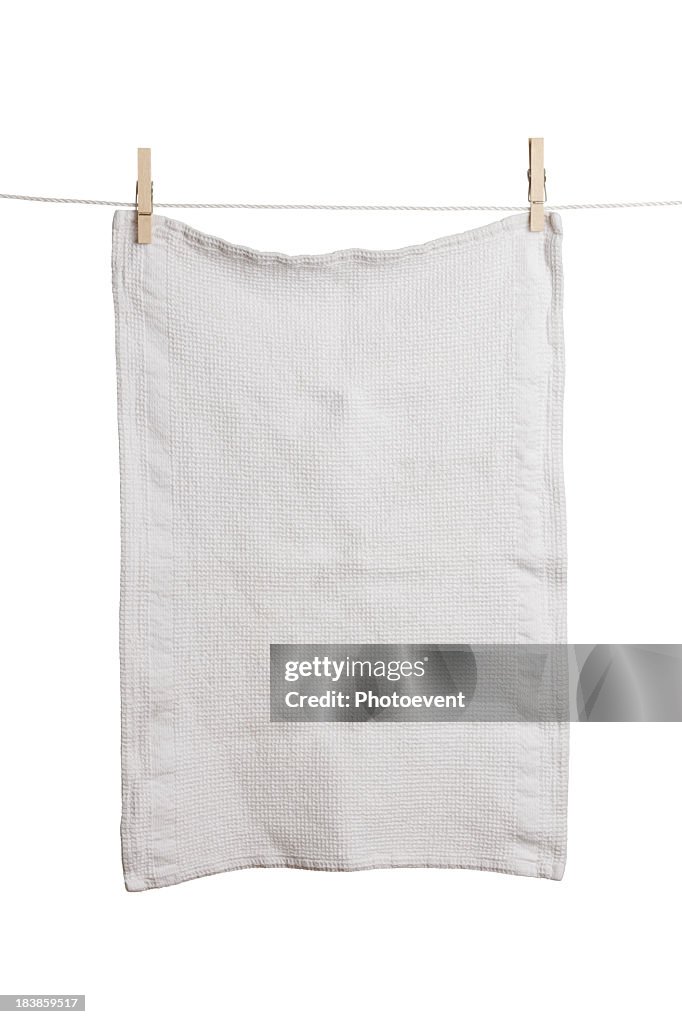 A plain white dish towel hanging on a line