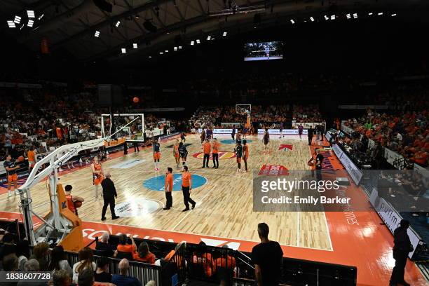 Players and officials mingle on court during the extended shot clock outage during the round 10 NBL match between Cairns Taipans and Sydney Kings at...