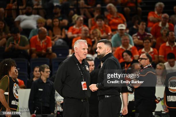 Cairns Taipans CEO Mark Beecroft talks with Head Coach Adam Forde during the shot clock outage and subsequent extended half time break during the...