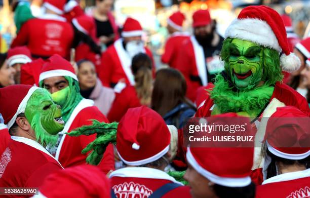 Runners dressed as The Grinch take part in the annual "Run Santa Run" Christmas race in Zapopan, Mexico, on December 10, 2023.