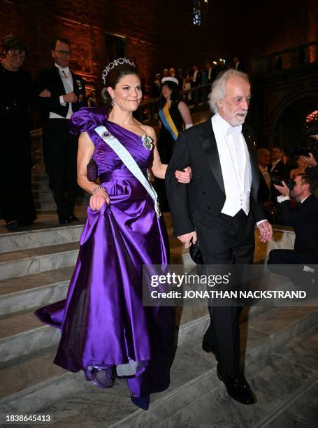 Crown Princess Victoria of Sweden arrives with 2023 Nobel Prize in Physics laureate Pierre Agostini for the Nobel Prize Banquet at the City Hall in...