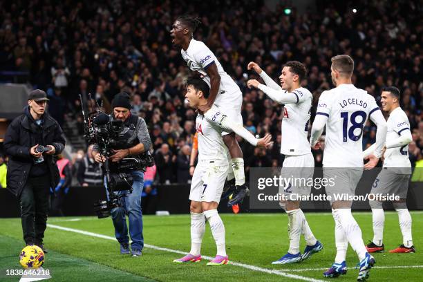 Yves Bissouma of Tottenham Hotspur jumps onto the back of Son Heung-Min of Tottenham Hotspur after the fourth goal during the Premier League match...