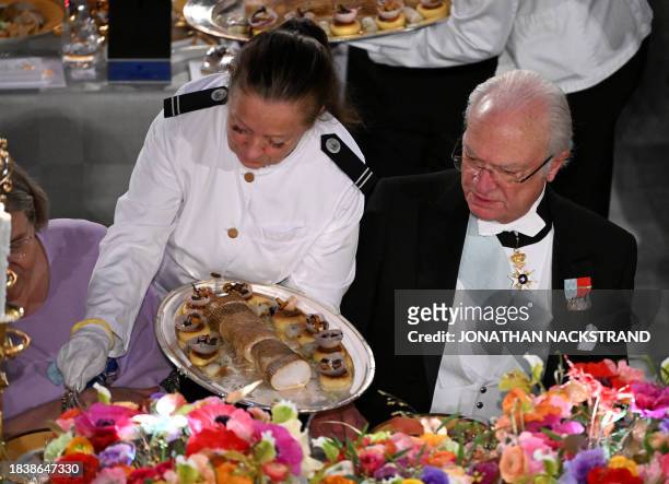 Sweden's King Carl XVI Gustaf attends the Nobel Prize Banquet at the City Hall in Stockholm, Sweden on December 10 following the Nobel awards...
