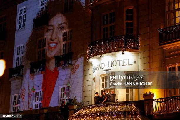 Kiana Rahmani and Ali Rahmani , children of the 2023 Nobel Peace Prize laureate Narges Mohammadi, and her husband Taghi Rahmani, waves from the...